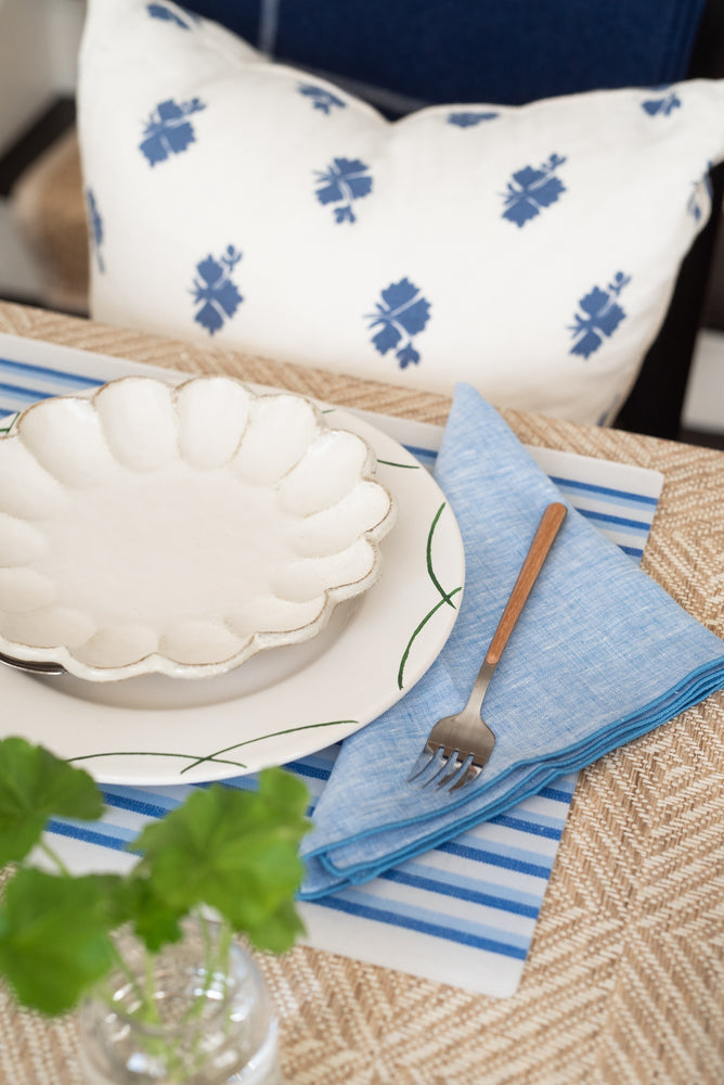 Blue Stripe acrylic placemat with blue linen napkin at stylish table